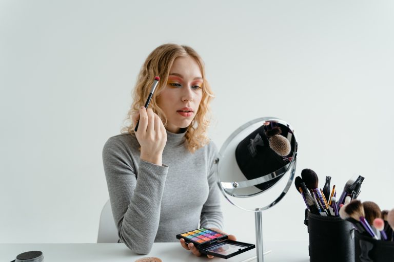 Woman-Holding-Eye-Makeup-Brush-scaled