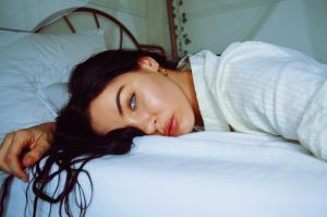 A-lady-lying-in-bed-with-her-eyes-open