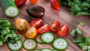 fruits-and-vegetables-arranged-on-a-wooden-cutting-board