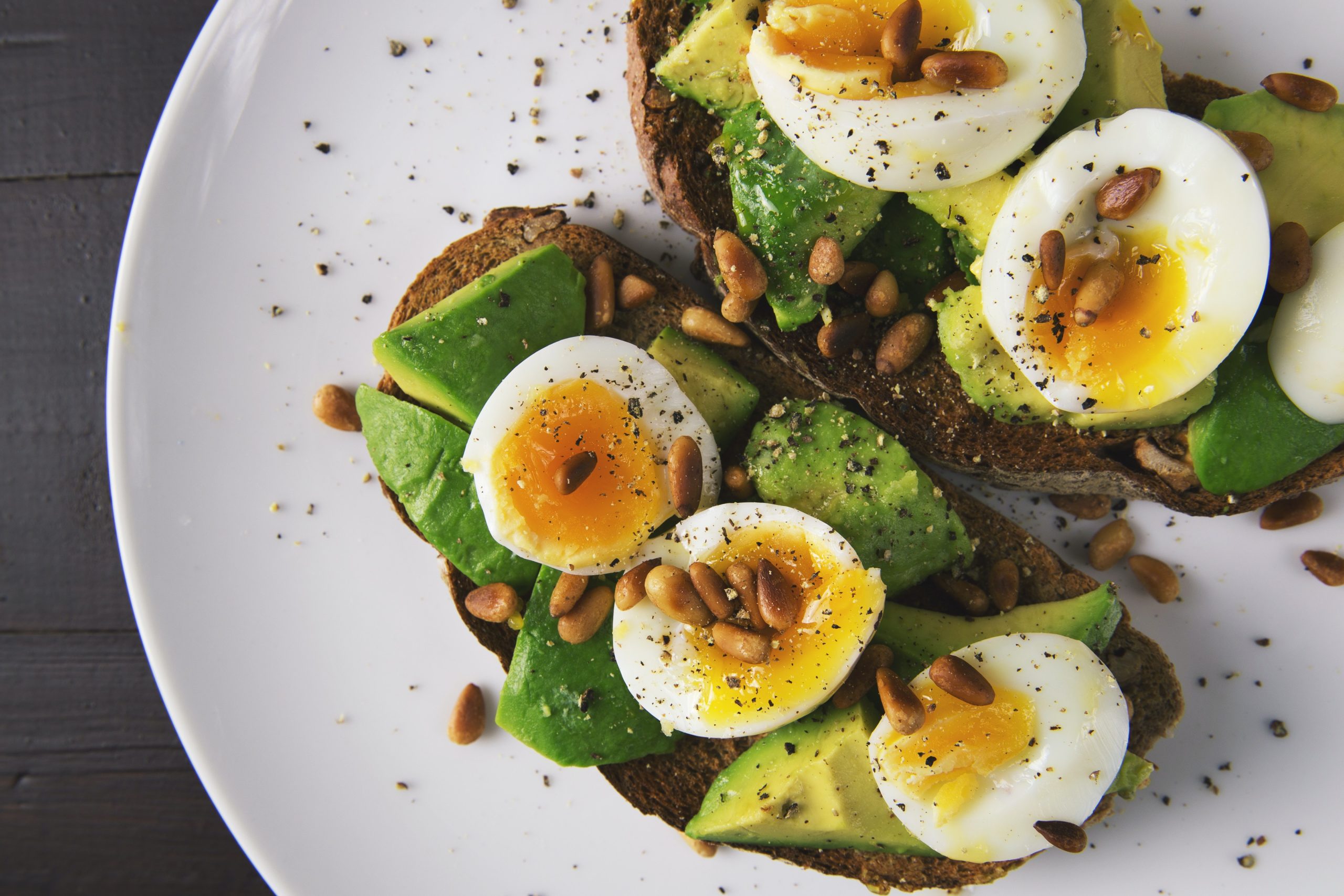 A-photo-of-a-person-eating-a-healthy-breakfast-such-as-eggs-avocado-and-nuts-