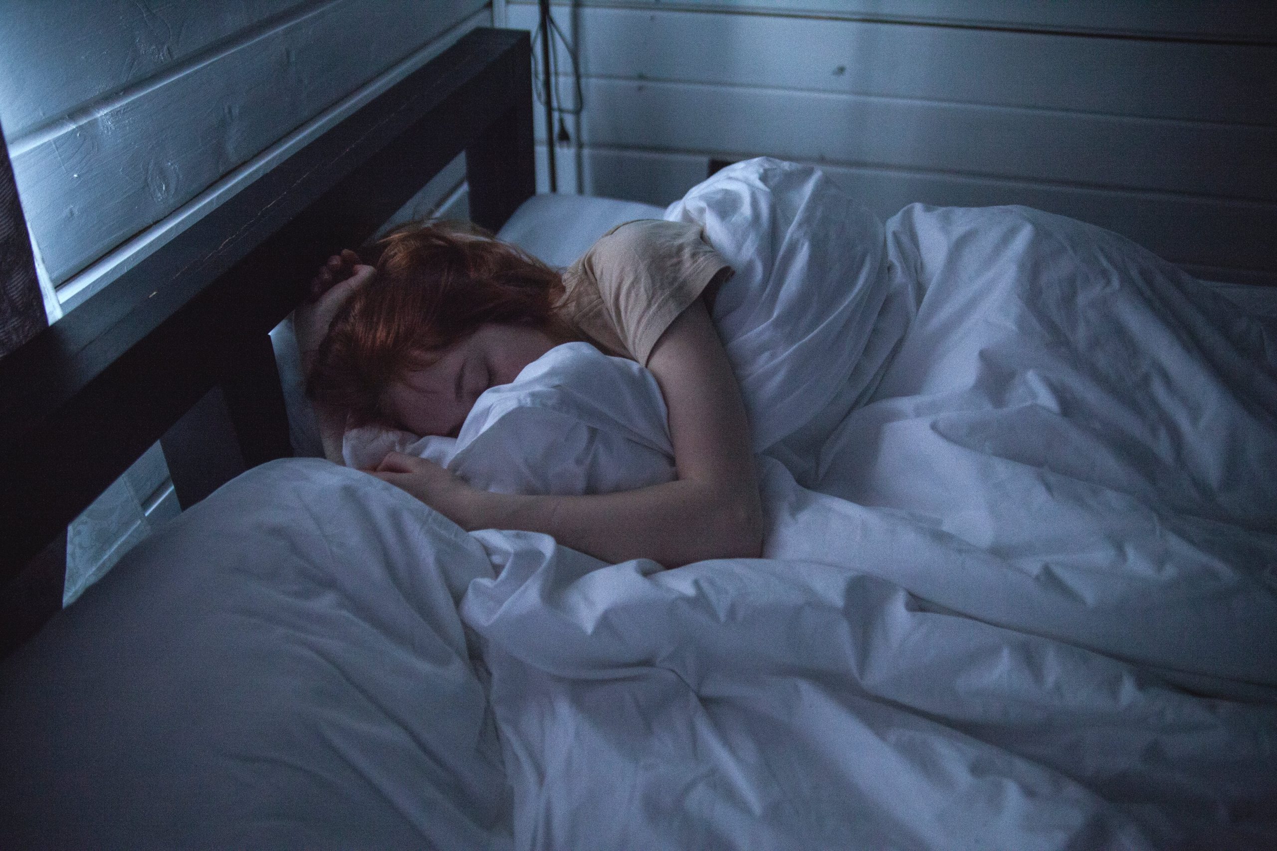 Person peacefully asleep in a cozy bed