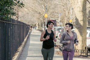 Happy-women-running-on-sidewalk