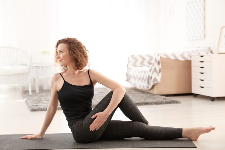 Beautiful-woman-practicing-yoga-in-morning-at-home