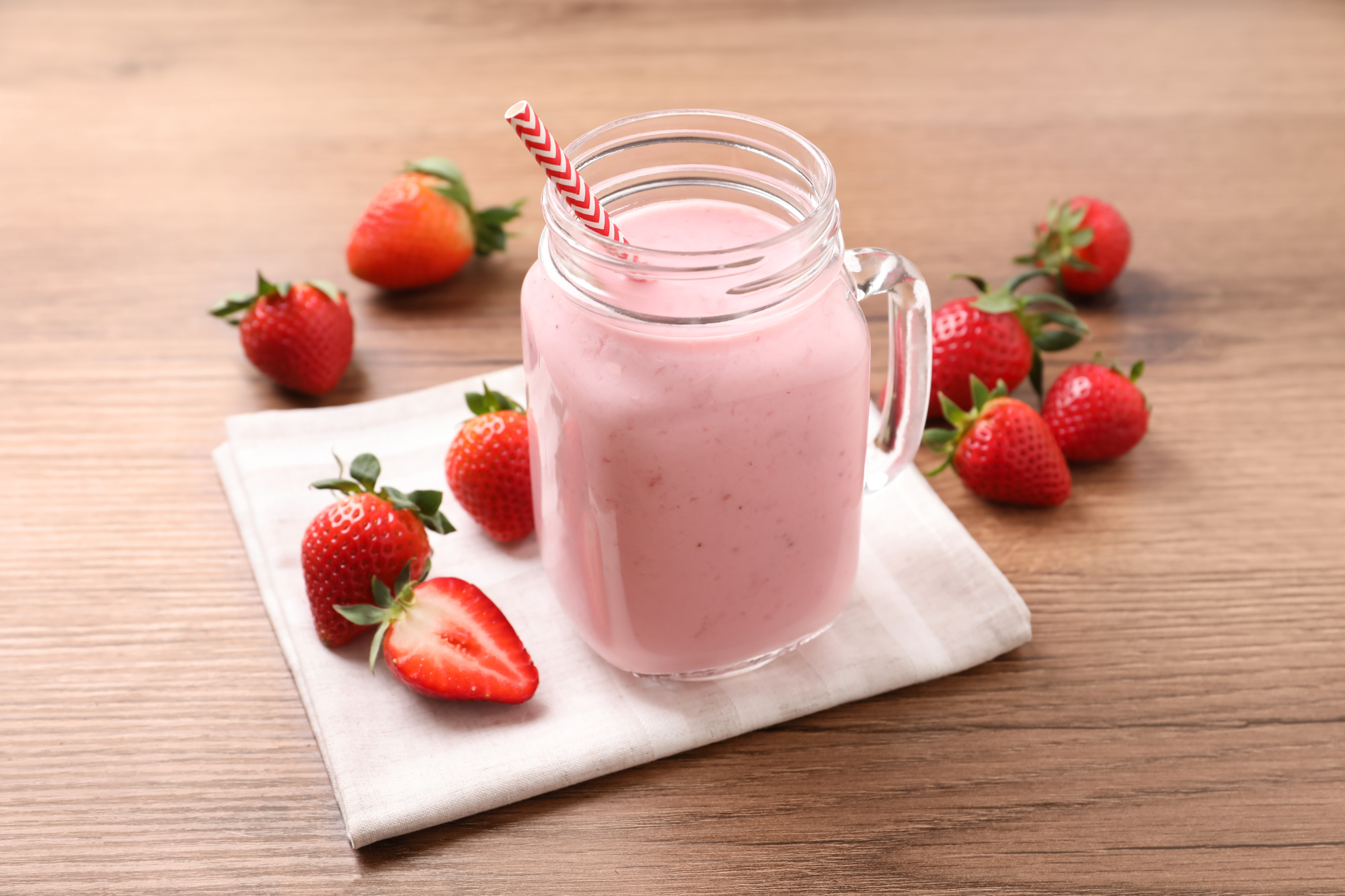 Delicious-strawberry-drink-in-mason-jar-on-wooden
