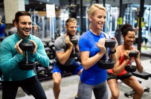 Group-of-young-fit-friends-people-doing-exercises-in-gym