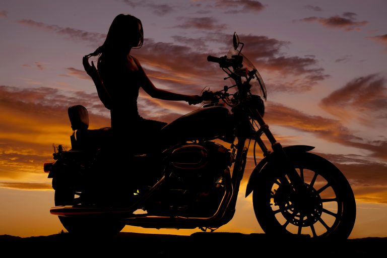 Silhouette-of-woman-sitting-on-motorcycle-—-Photo