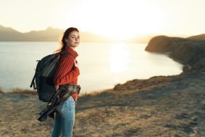 Woman with backpack travel rocky mountains walk lifestyle
