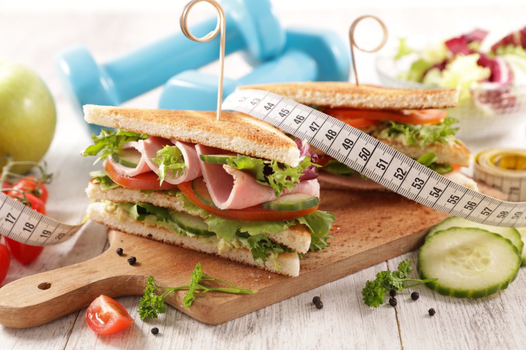 Club sandwich with meter tape and dumbbell