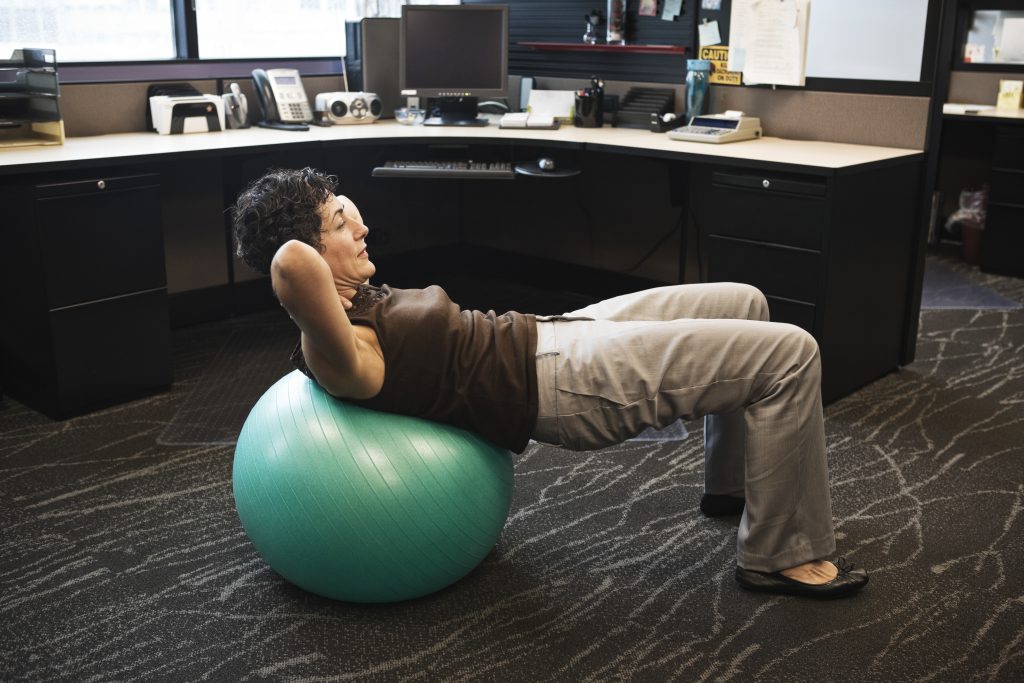 caucasian-woman-working-out-on-a-bosu-ball-in-her-