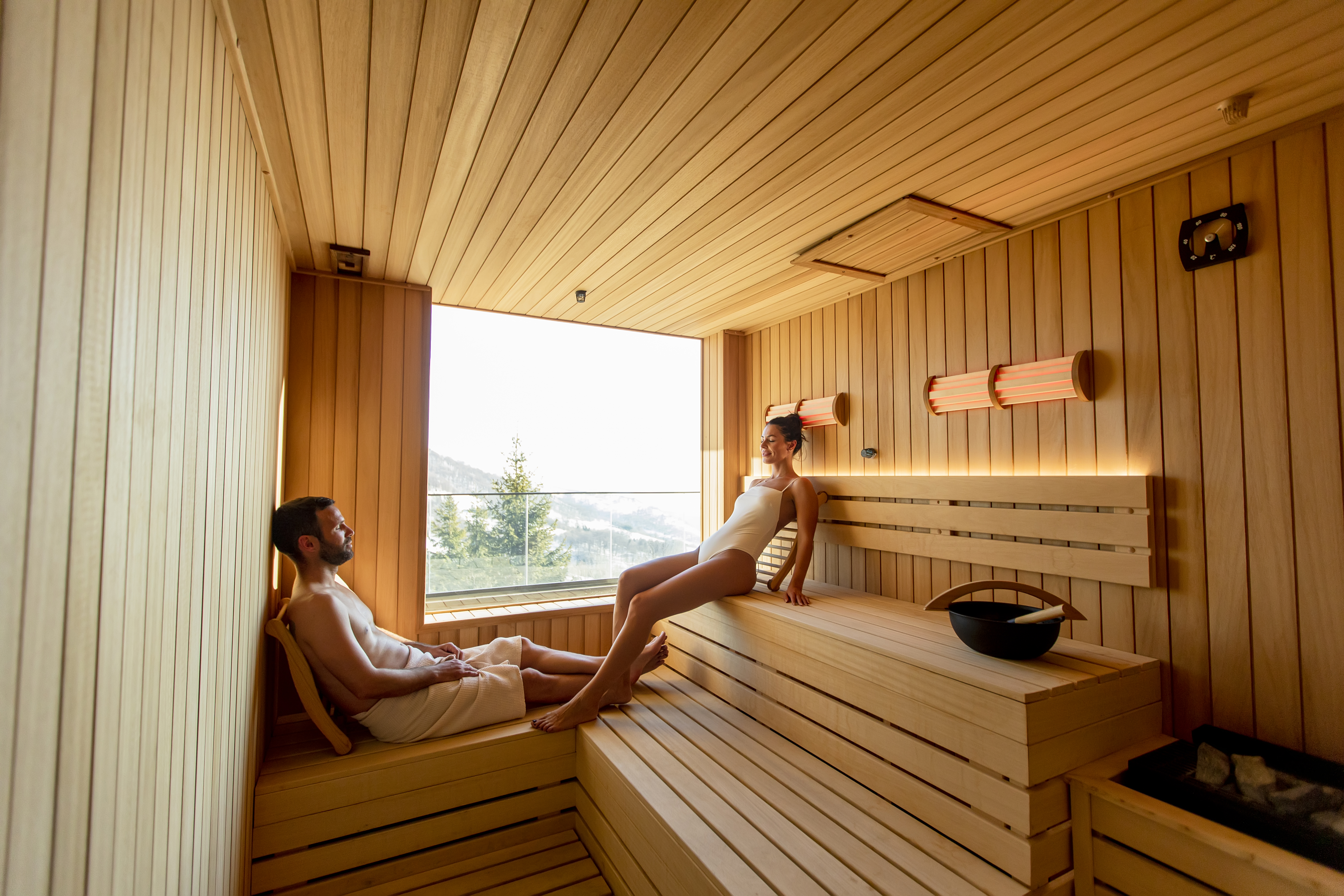 young-couple-relaxing-in-the-sauna-and-watching