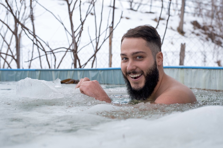 young-smiling-male-having-fun-while-swimming-in-an