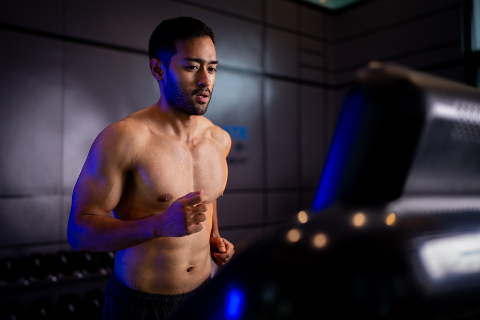 A strong Asian man is exercising to build muscle.