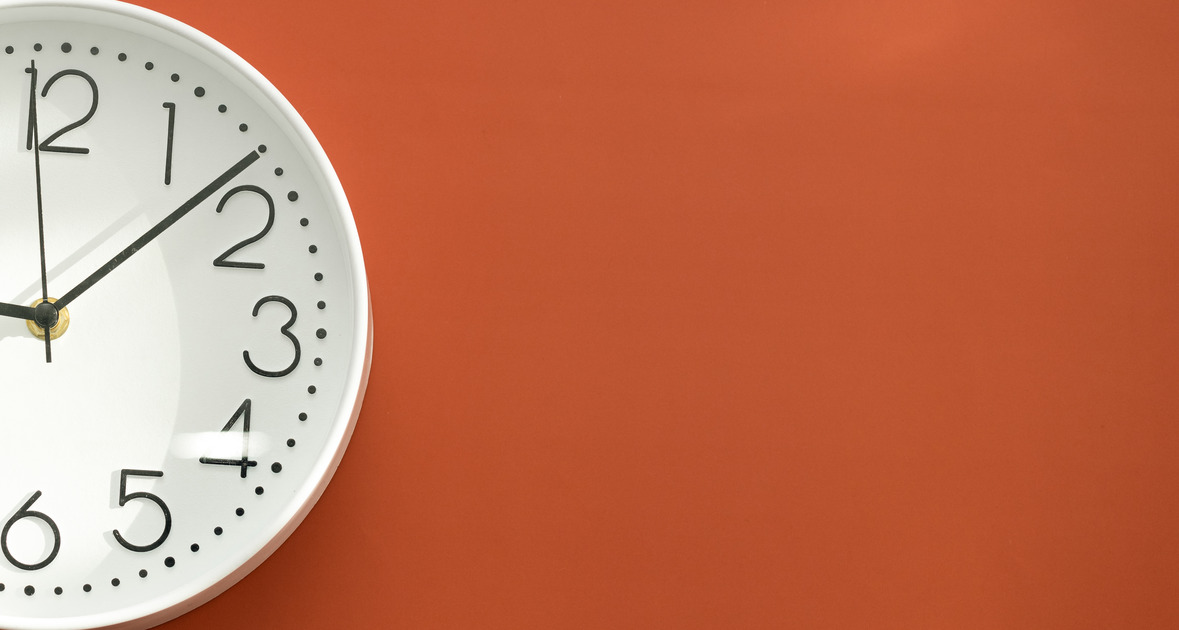 Clock on a red background, the concept of fasting time management.
