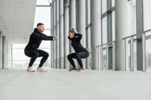 Fitness-couple-doing-squats-together