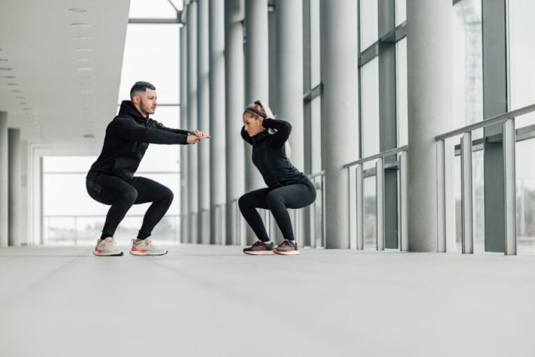 Fitness-couple-doing-squats-together
