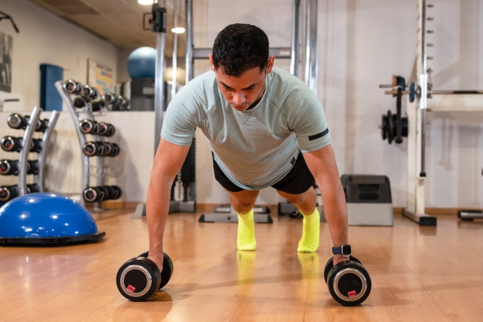 Portrait of a Caucasian man doing push-ups with weights