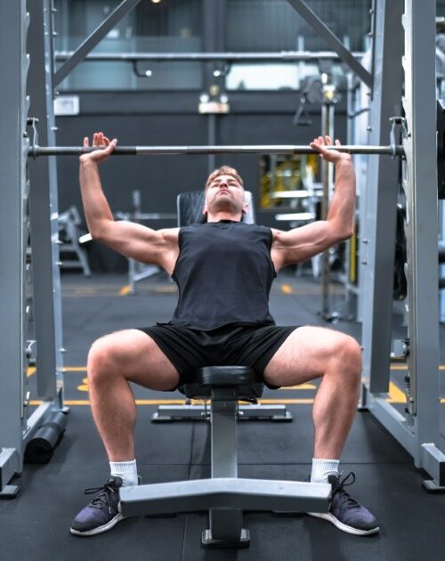 Young man training in a fitness club