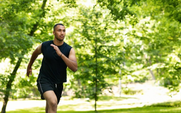 Serious-attractive-millennial-african-american-man-athlete-sprinter-training-running-at-summer