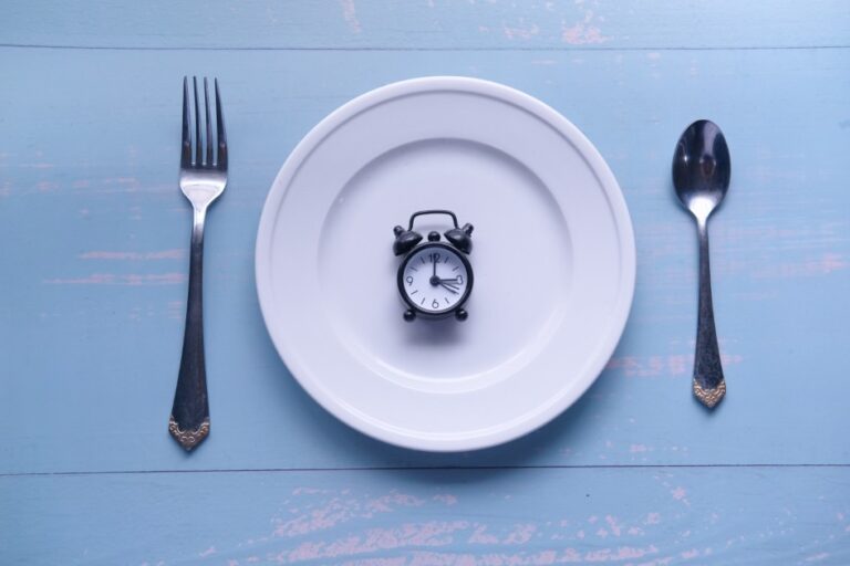 Dinner-Time-An-Alarm-Clock-Set-on-a-Plate-Surrounded-by-Various-Cutlery-Utensils