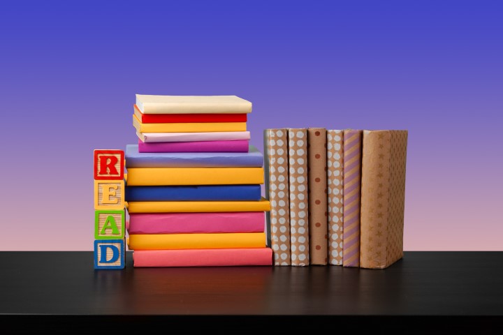 Stack-of-books-on-black-wooden-table