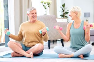Fitness-senior-and-couple-with-dumbbell-for-exercise-wellness-and-muscle-training-on-mat-with-hap