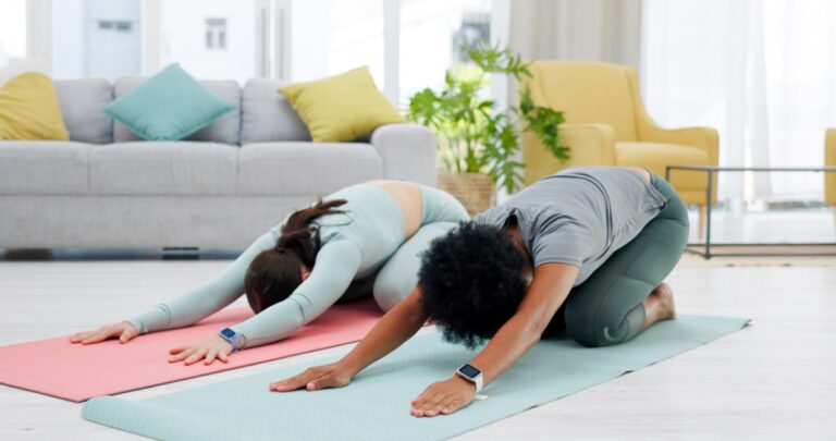 Friends-child-pose-and-yoga-of-women-in-home-for-stretching-wellness-and-health.-Fitness-stretch