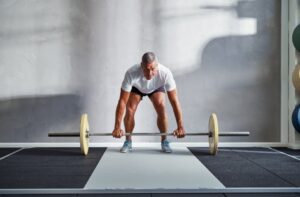 Fit-senior-man-lifting-weights-alone-in-a-gym.jpg