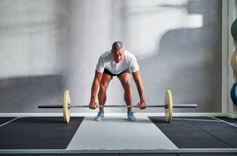 Fit-senior-man-lifting-weights-alone-in-a-gym.jpg