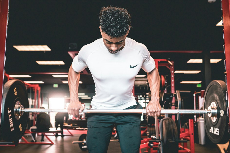 Male lifting weights inside a gym